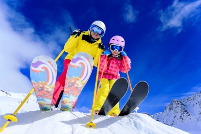 Ski, skiers, sun and winter fun – skiers enjoying ski vacation